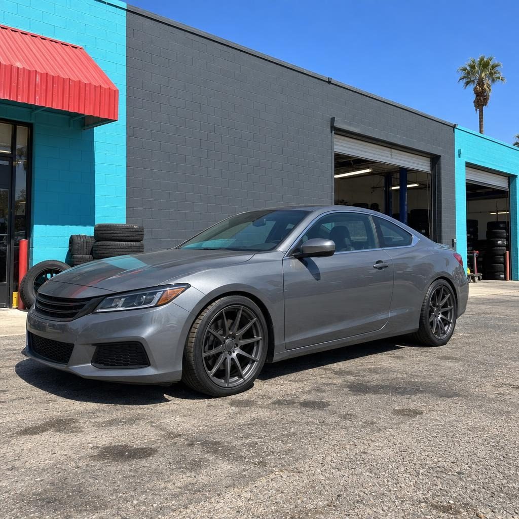 Gray coupe parked in front of the slate wall