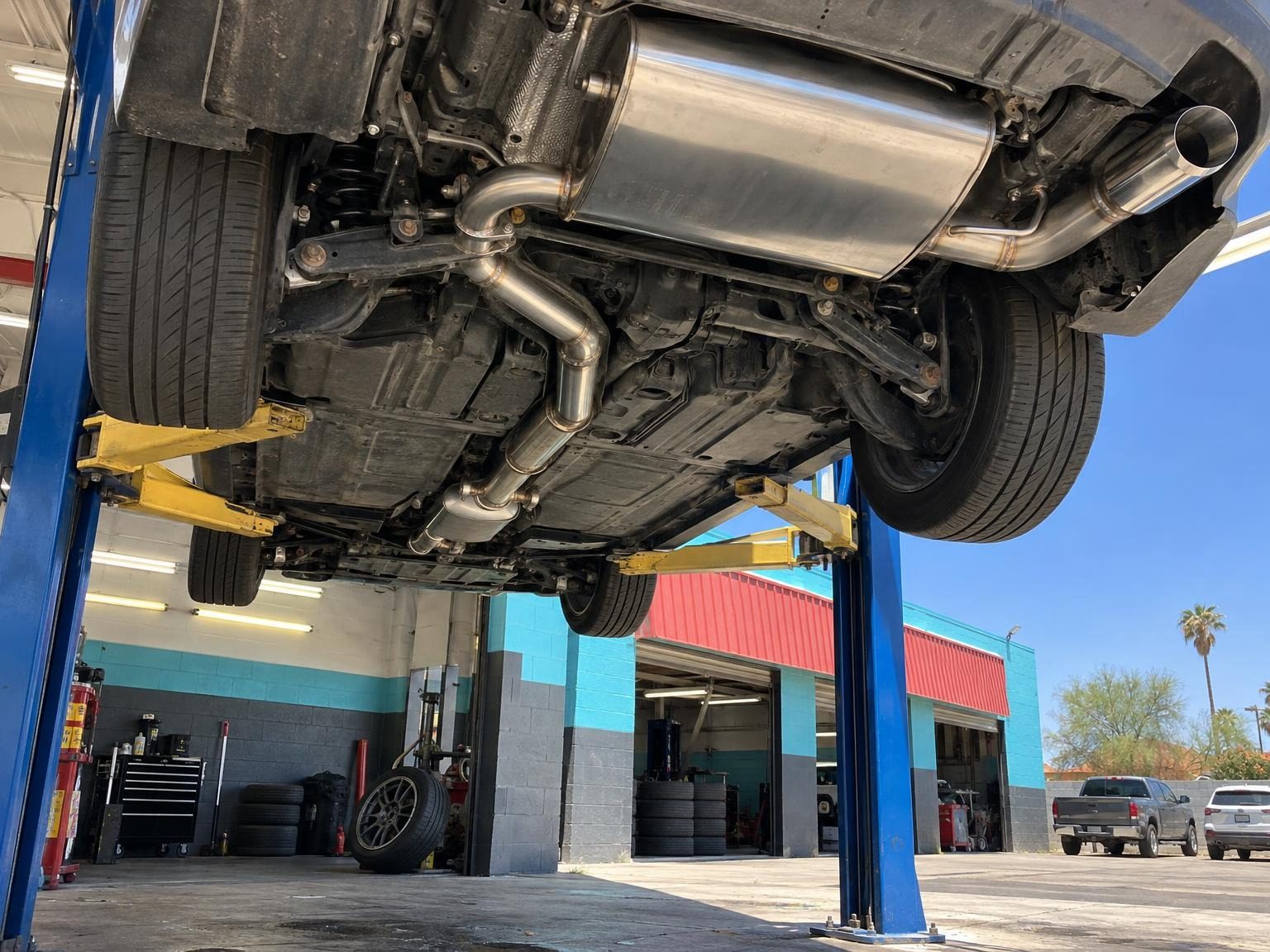 Underside of a car on the lift with a new exhaust system